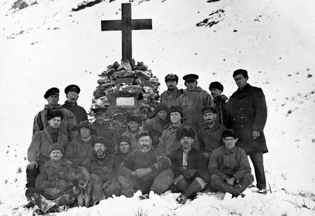 Wilkins at rear fourth from right at the memorial the crew built for Shackleton